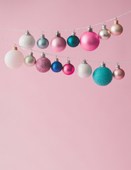 colorful pastel chrstmas decoration balls on pink background. minimal new year concept with creative