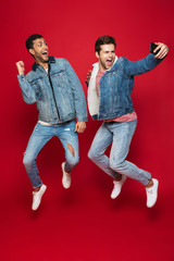 Canvas Print - Two cheerful young men jumping isolated