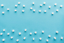 Top View Of White Sugar Cubes With Copy Space On Blue Background