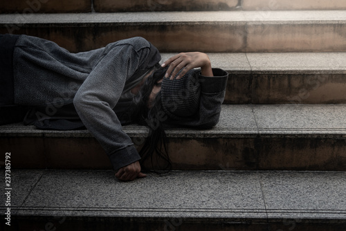 Fotografie, Obraz Beggars, Homeless people Lie on the steps, ask for a fraction of money from people travelng to buy food to live, to homeless concept