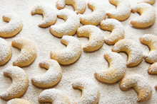 German And Austrian Traditional Christmas Cookies Vanilla Crescents On White Tray Powdered With Castor Sugar. Beautiful Light. Food Pattern. Holiday Baking Concept