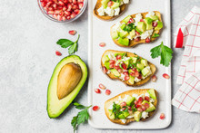 Avocado Feta Cheese Pomegranate Seeds Crostini. Top View, Space For Text.