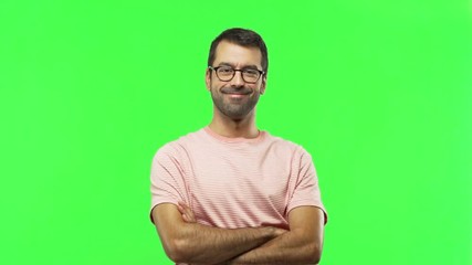 Wall Mural - man keeping the arms crossed in confident expression  on green screen chroma key background