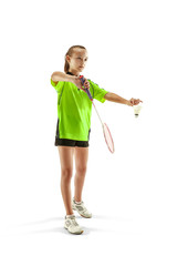 The one caucasian young teenager girl playing badminton at studio. The female teen player isolated on white background in motion