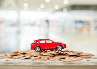 Wall Mural - Golden coins and toy car on  background