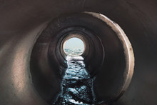 Sewage Flows Into The Sea. Inside View Of The Pipe.