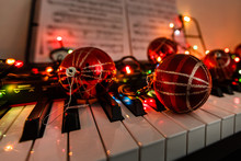 A Piano With Christmas Lights And Tree
