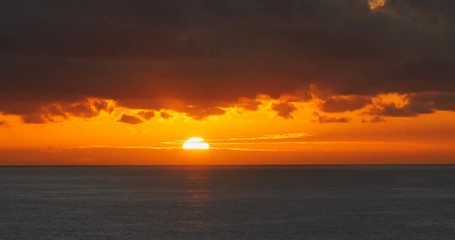 Wall Mural - Red sunrise dawn over sea water surface and clouds time lapse