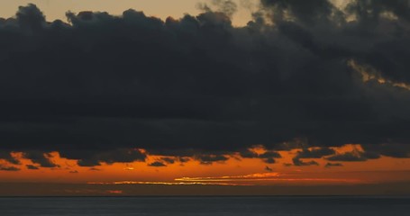 Wall Mural - Red sunrise dawn over sea water surface and clouds time lapse