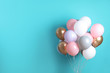 © New Africa - Colorful party balloons on blue background. Space for text