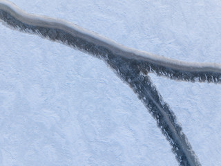 Aerial view of a rift on the ice of a winter lake 