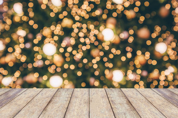 Wood table top with abstract christmas holiday festive bokeh light on tree blurred background for montage product display