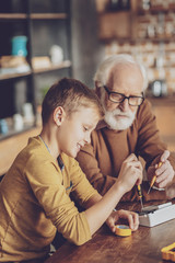 Wall Mural - Delighted boy repairing his gadget