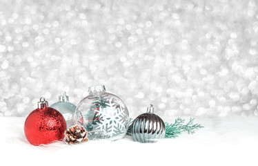 Leinwandbilder - Christmas decoration ball on white fur at silver bokeh light background,Holiday greeting card