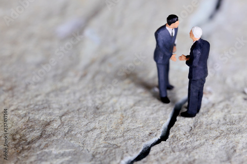 亀裂を修復し握手するビジネスマン Obraz na płótnie