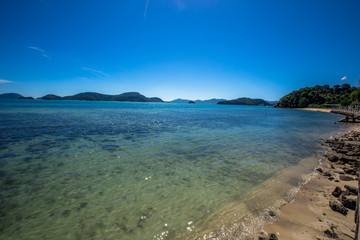 Background of the sea, blue sky wallpaper, the beauty of nature in bright weather, green water looks refreshing.