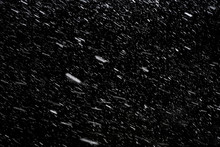 Falling Down Real Snowflakes At The Snowstorm Weather Isolated On Black Background. For Use As Layer Snow In Your Project.