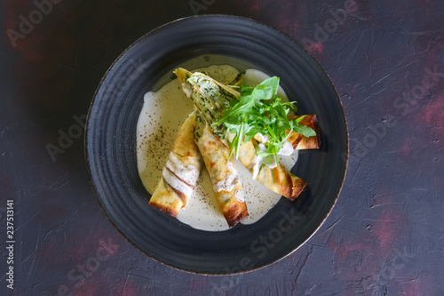 Fotografía Thin pancakes stuffed with arugula and cheese