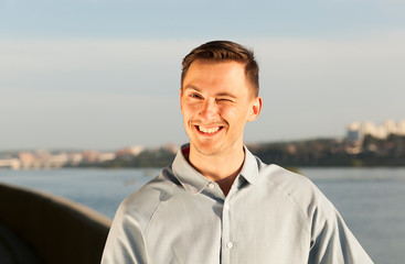 Wall Mural - portrait of a smiling young man. young brunette man rejoices, happy man, pleasure and satisfaction