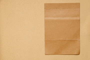 Sticker - fold brown paper on brown fabric texture