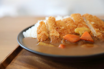 Wall Mural - Curry rice with fried pork tonkatsu Japanese food on wooden table