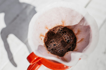 Wall Mural - Delicious freshly ground morning coffee powder in the coffee filter