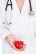 © taskin - Medicine doctor holding red heart shape in hands on hospital background, medical concept
