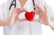 © taskin - Medicine doctor holding red heart shape in hands on hospital background, medical concept