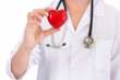 © taskin - Medicine doctor holding red heart shape in hands on hospital background, medical concept