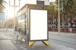 Empty white advertising urban billboard near city bus stop, placeholder template on a street, space for design layout.