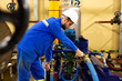 Technician maintenance of industrial oil pump on factory
