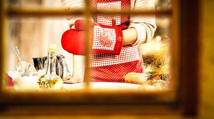 Wall Mural - Woman cook in kitchen and winter window space 