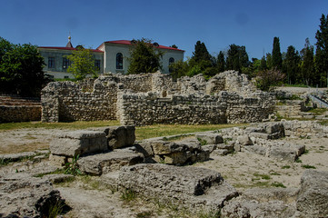 Sevastopol, Crimea, Russia - May 12, 2015: Khersoneus Tauride / Ruins of the ancient amphteater. Stone tribunes of the amphitheater against the blue sky.