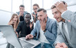 © ASDF - Frustrated females and males sales managers working in showroom, looking at laptop monitor
