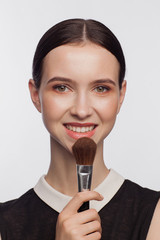 Makeup artist holding makeup brush