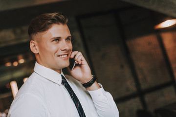 Wall Mural - Concept of success and confidence. Close up portrait of stylish smiling businessman talking by phone. Copy space on right