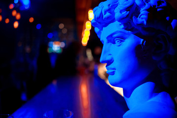 a statue of a man in red and blue light