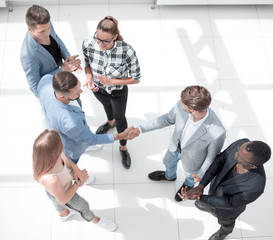 Team leaders meet multiracial interns in office explaining new j