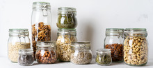 Glass Jars With Superfoods Nuts And Cereals Stacked On Top Of Each Other