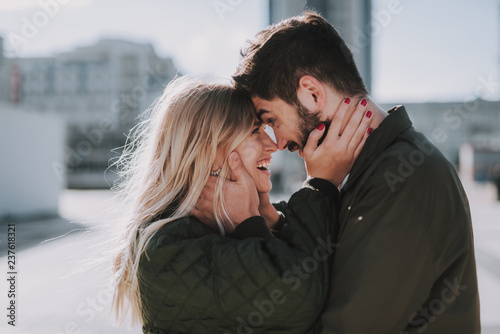 Fotomural Beautiful young couple feeling happy while touching foreheads