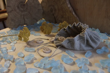 Wooden handmade witch runes with a linen pouch, blue cristals and yellow flowers in a rustic style