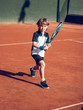 © ADDICTIVE STOCK - Boy playing tennis on hard court