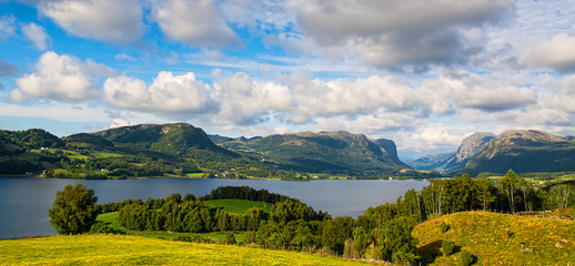 Wall Mural - Amazing nature view with fjord, mountains and fields. Beautiful clouds. Location: Scandinavian Mountains, Norway, Europe. Artistic picture. Beauty world.