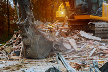 Old House Being Demolished By A Large Backhoe