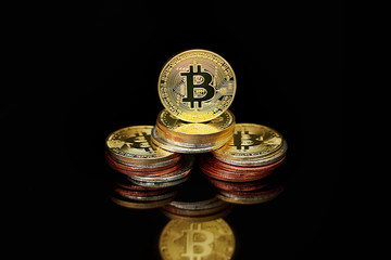 Wall Mural - Close-up virtual currency bitcoin on black background. Golden, silver, bronze, bitcoins on black background. Physical Bitcoin. Cryptocurrency trading concept.