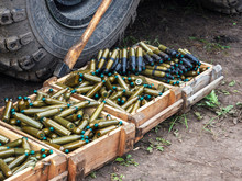 Many Wooden Boxes With Ammunition. Cartridge Tape. Cartridges From A Small-caliber Cannon Of A Tank Or Armored Personnel Carrier.