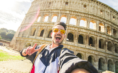 Wall Mural - Happy tourist takina selfie at the Colosseum in Rome, Italy