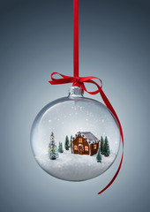 cozy christmas gingerbread house in glass ball over gray background with copy space