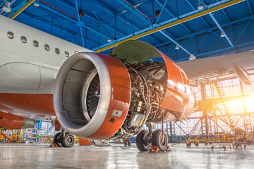 Airplane in the hangar, the engine under repair close-up.