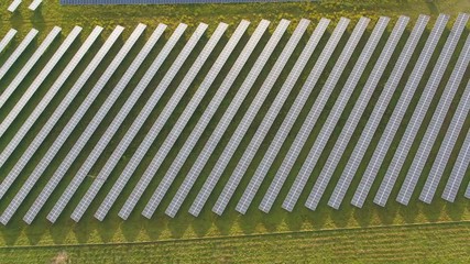 Wall Mural - drone aerial of a solar power plant next to the highway in agricultural landscape